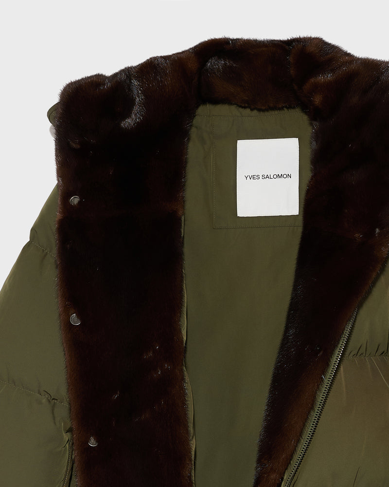 A line down jacket in technical fabric with long-haired mink hooded bib