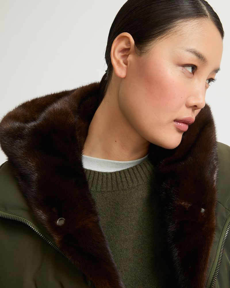 A line down jacket in technical fabric with long-haired mink hooded bib