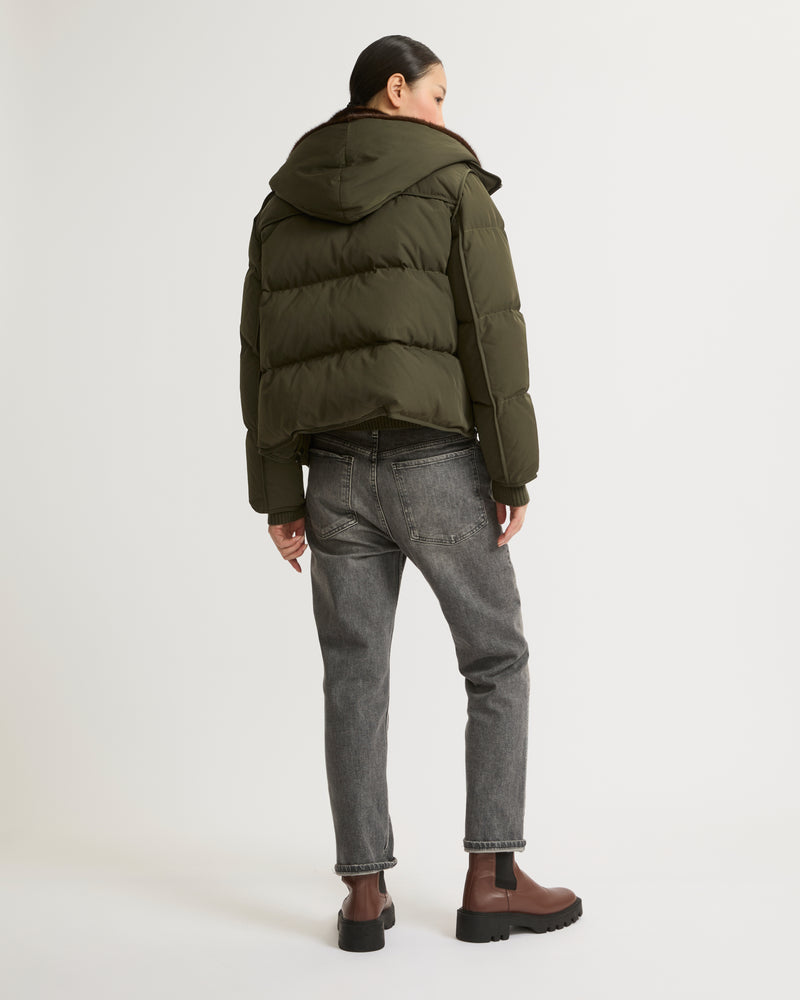 A line down jacket in technical fabric with long-haired mink hooded bib