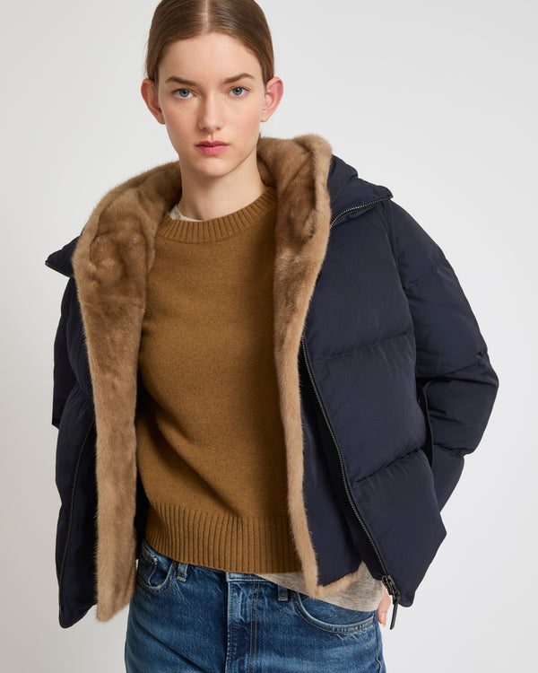 A line down jacket in technical fabric with long-haired mink hooded bib