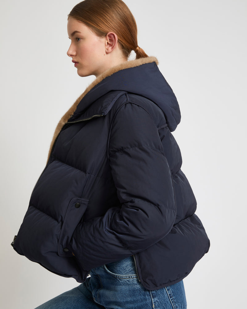 A line down jacket in technical fabric with long-haired mink hooded bib