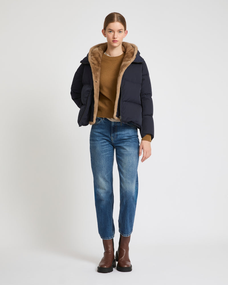 A line down jacket in technical fabric with long-haired mink hooded bib