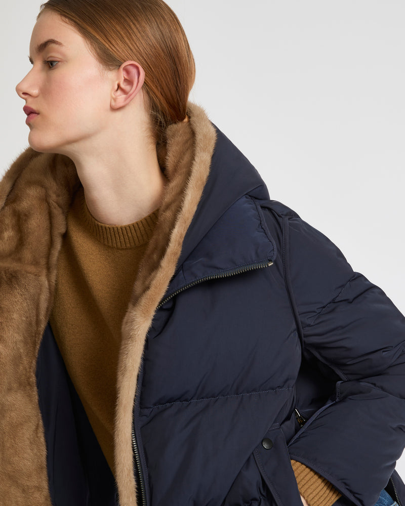 A line down jacket in technical fabric with long-haired mink hooded bib