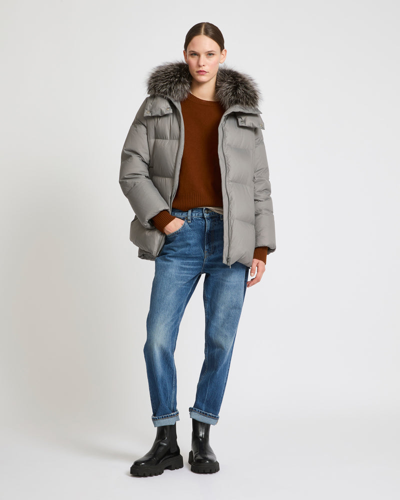 A line down jacket in water-repellent technical fabric with fox fur collar