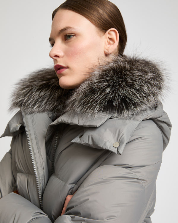 A line down jacket in water-repellent technical fabric with fox fur collar