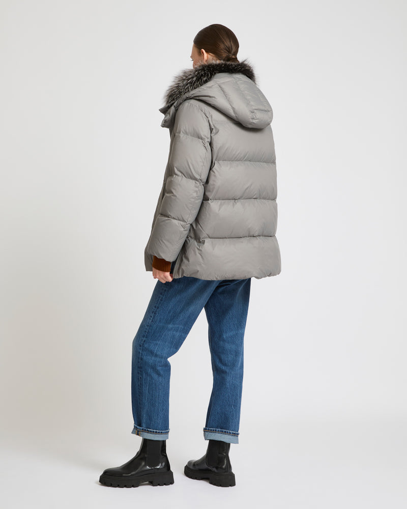 A line down jacket in water-repellent technical fabric with fox fur collar