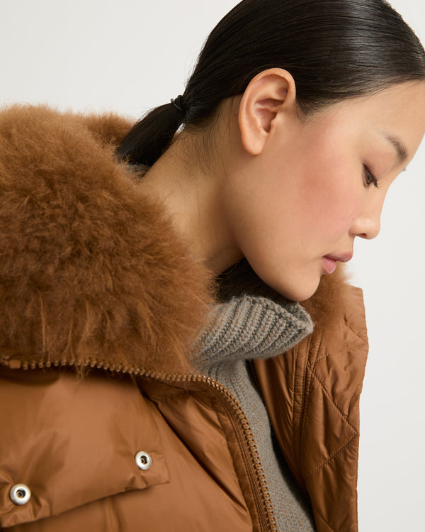 A line down jacket in water-repellent technical fabric with fluffy lambswool collar