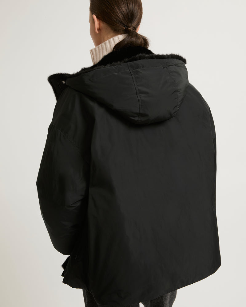 Hooded down jacket in technical fabric and mink fur